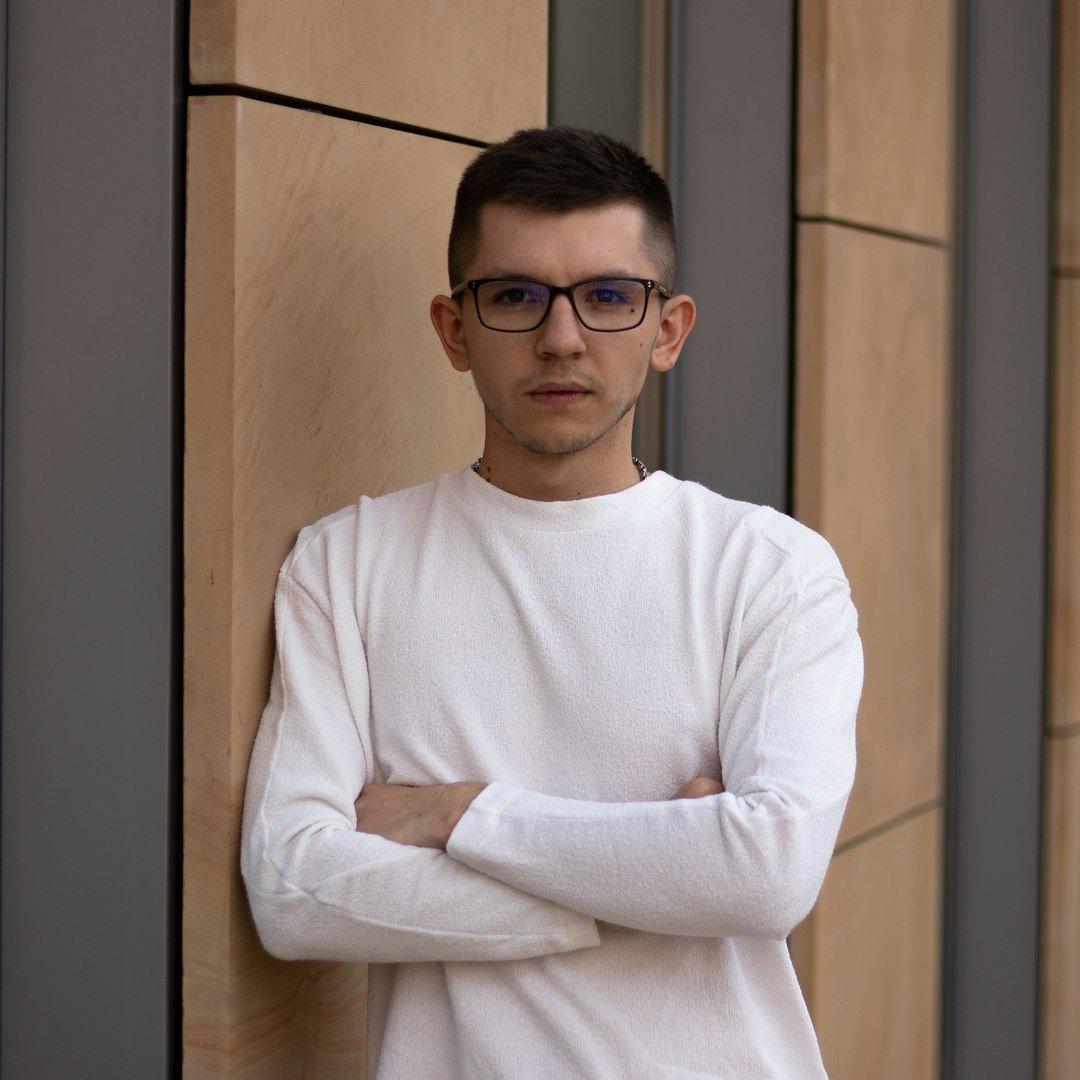 Мужчина средних лет в очках, серьёзное выражение лица, офисная обстановка